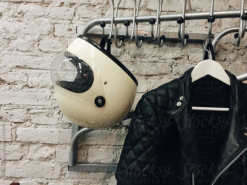 Moto helmet and leather jacket on a hanger