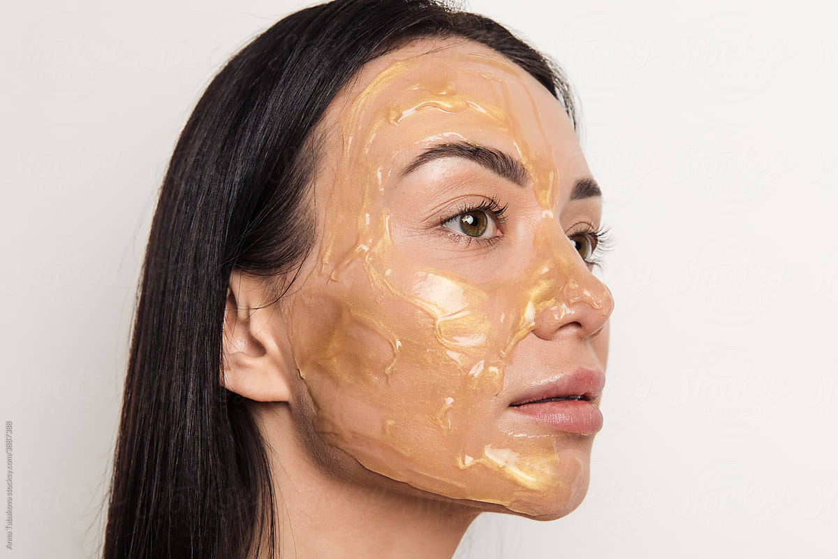 Woman with gold gel facial mask