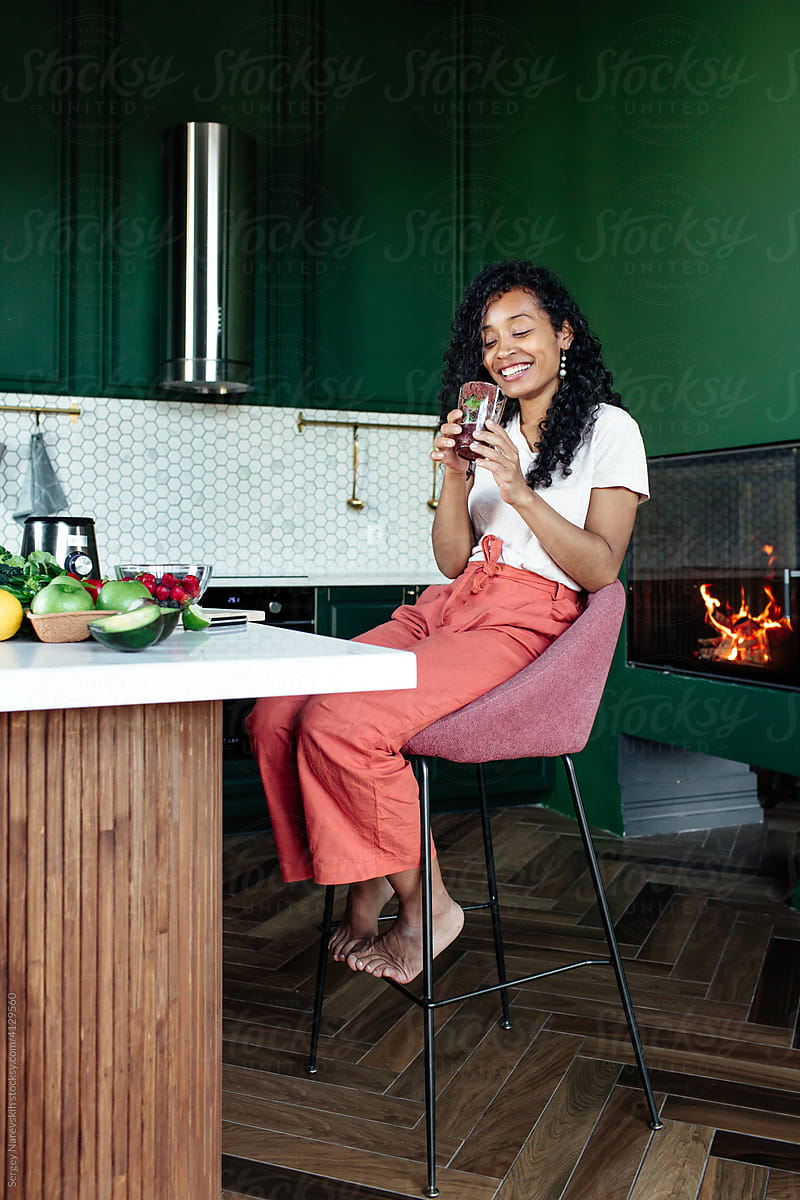 Black woman having lunch with fresh smoothie