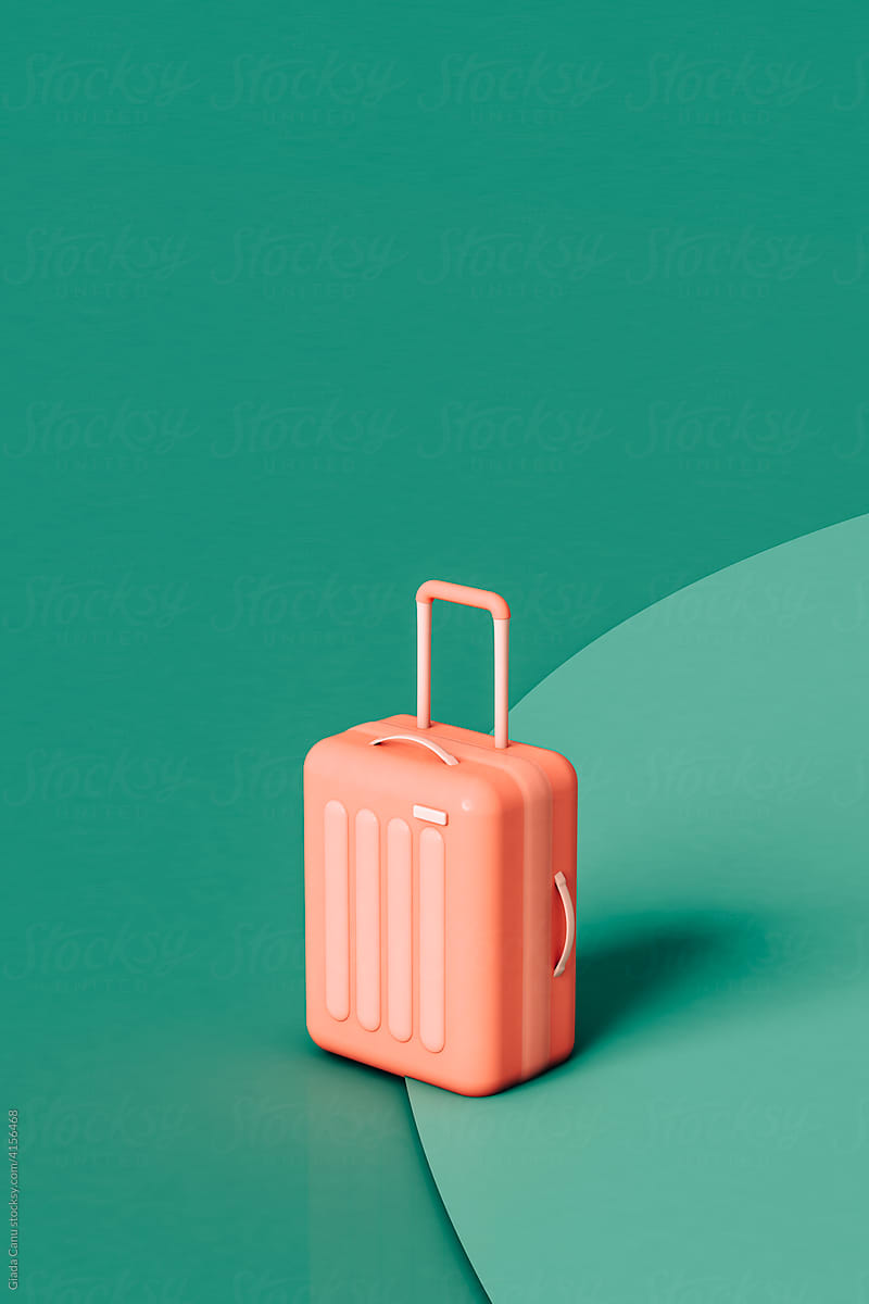 pink Suitcase on a green background. travel concept.