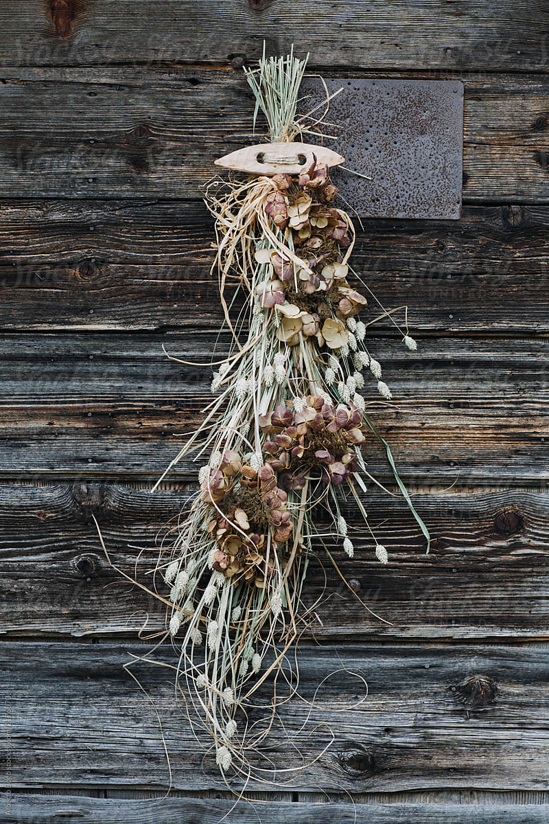 Dried floral bouquet hanging from old door