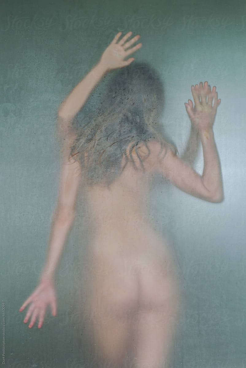 Silhouette of a young naked women in a shower room