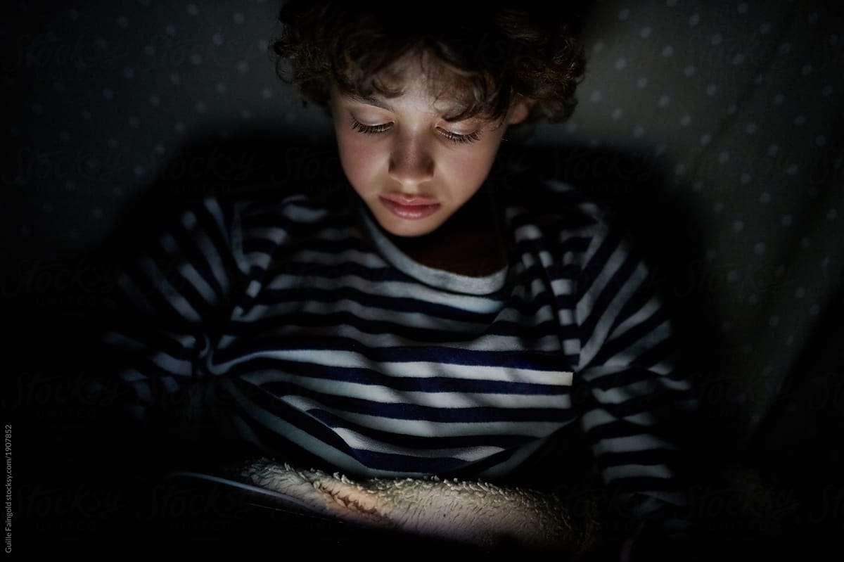 Boy using device late at night