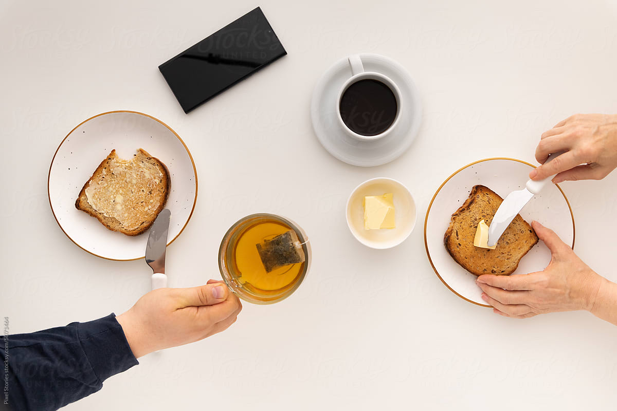 Food: people eating breakfast with toasts, butter, coffee and tea