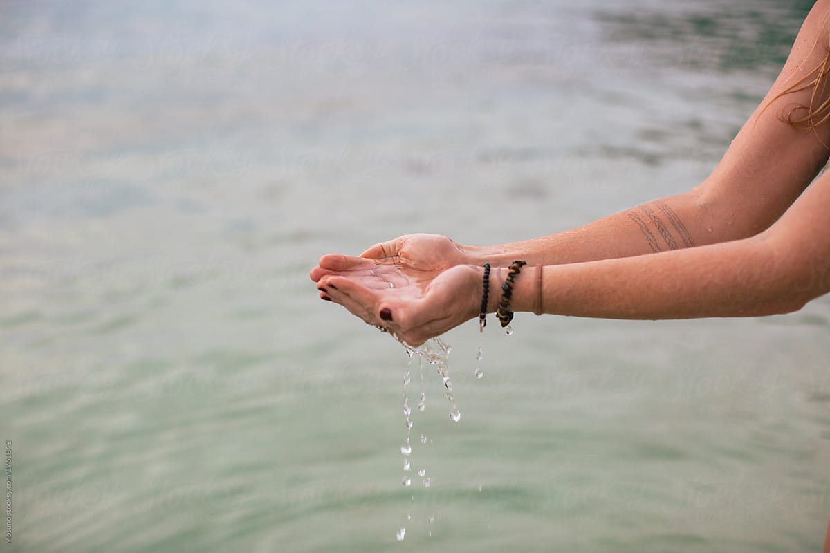 Female Hands Holding Sea Water