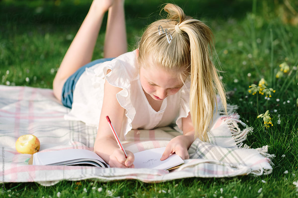 Tween Girl Drawing Outdoors In Early Summer By Stocksy Contributor 3353
