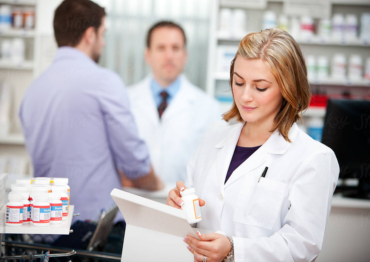Pharmacy: Pharmacist Stocking Medicing on Shelves