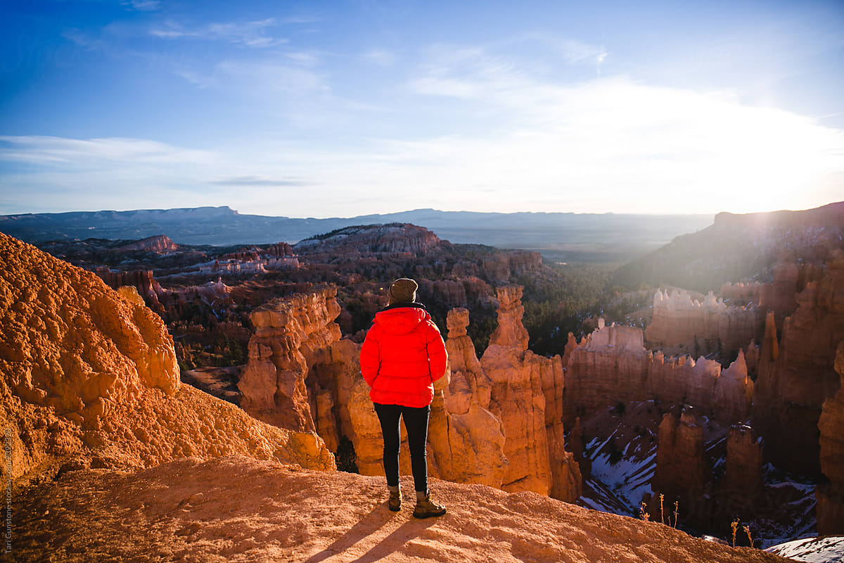 Woman takes in sunrise vista at Bryce Canyon National Park