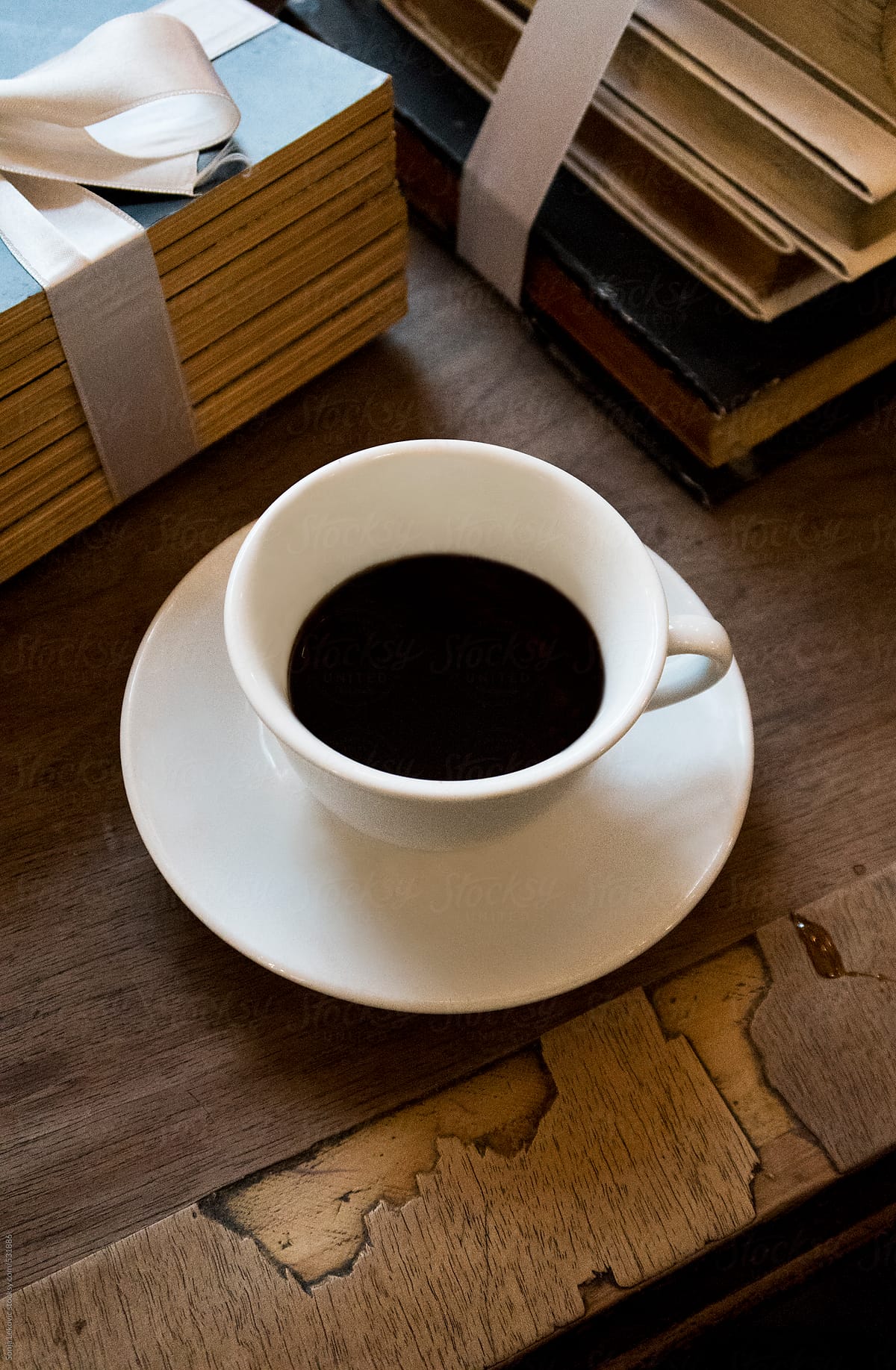 white cup of coffee and books on the table