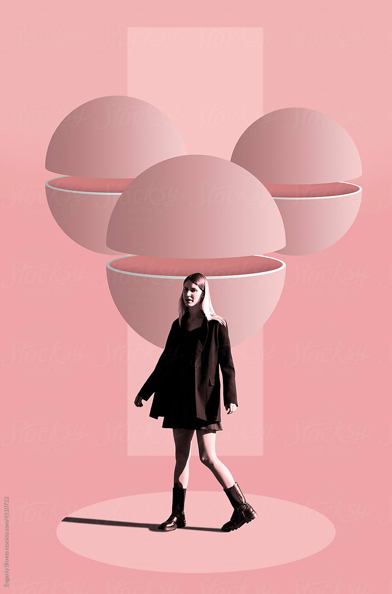 Woman standing against group of divided spheres