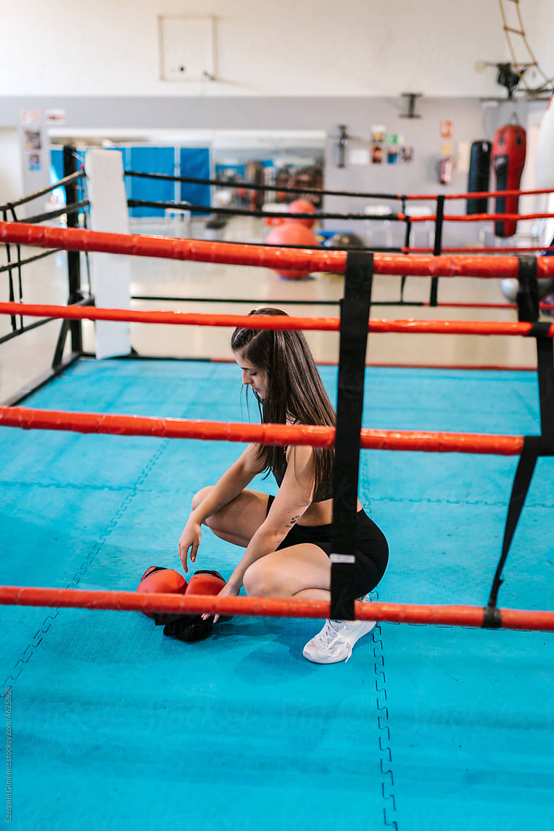 Woman preparing for boxing workout on ring