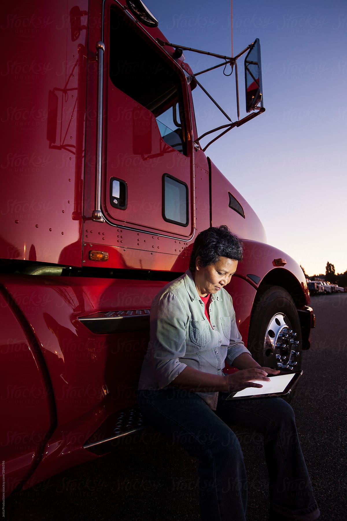 Truck driver working on a computer tablet.