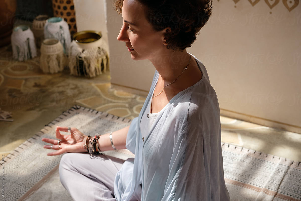 Peaceful woman meditating on floor