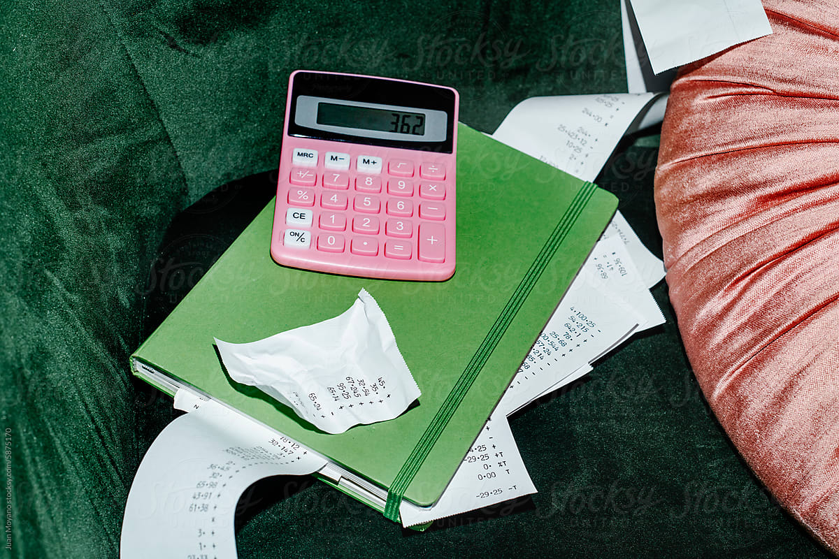 pink calculator, notebook and different calculations