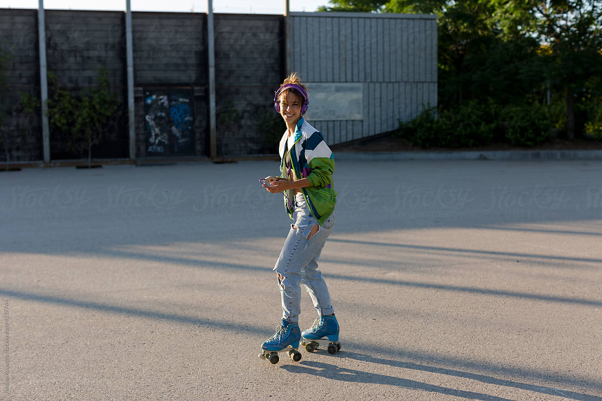 Roller-skater girl smiling at camera while skating