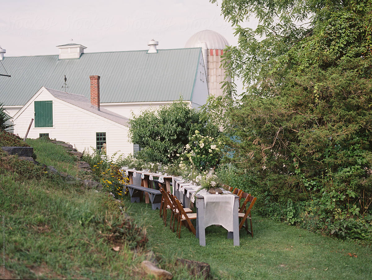 dinner event set up with long table and chairs at a dairy farm