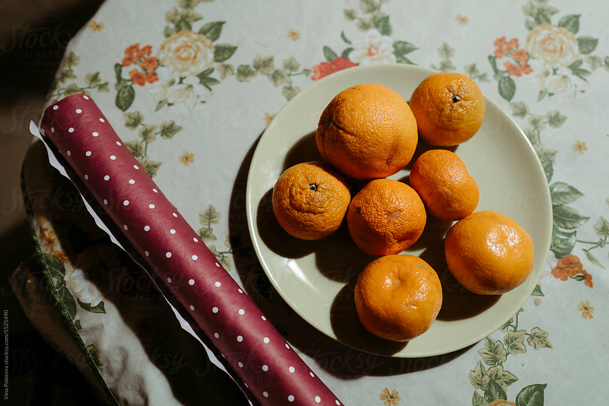 Tangerines and wrapping paper for gifts.