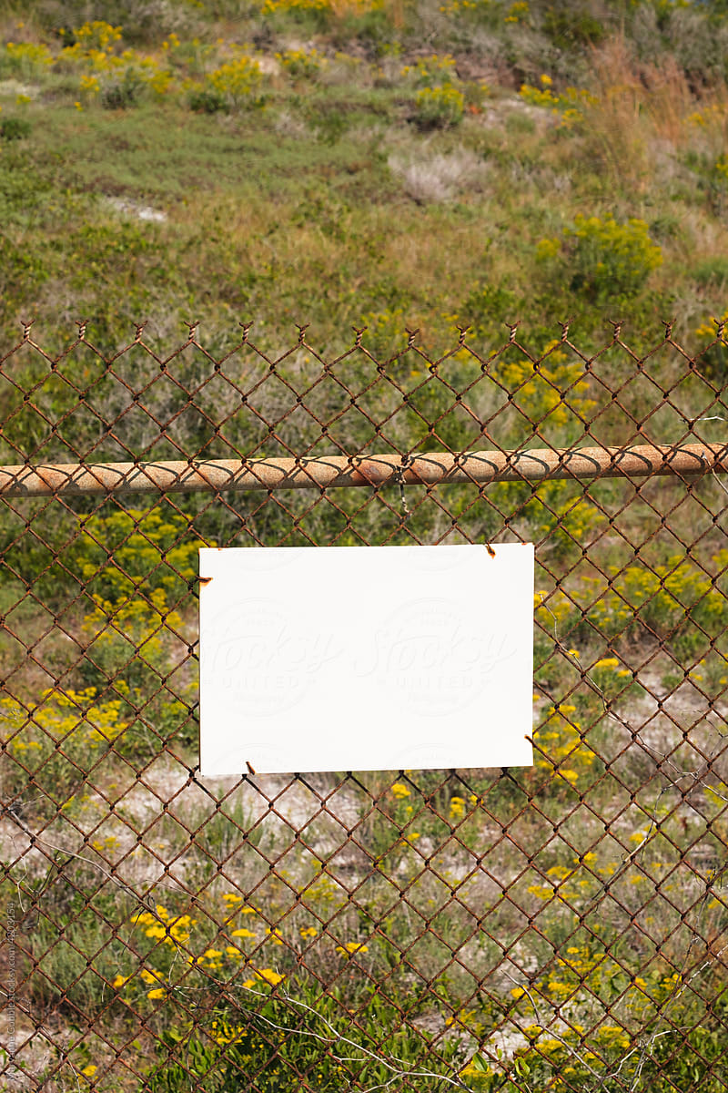 Blank White Sign on Old Fence