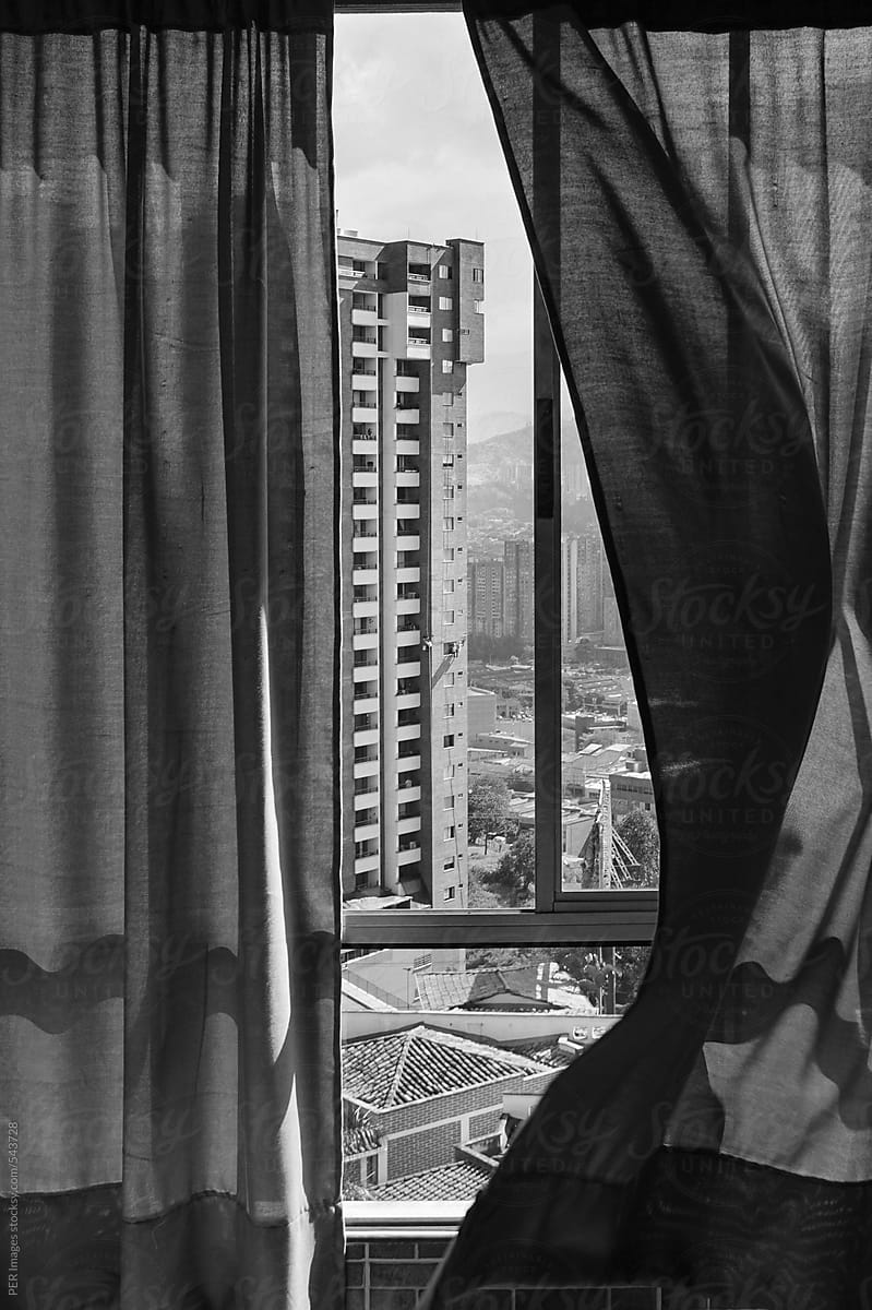 Window curtains moving in the wind in high rise building