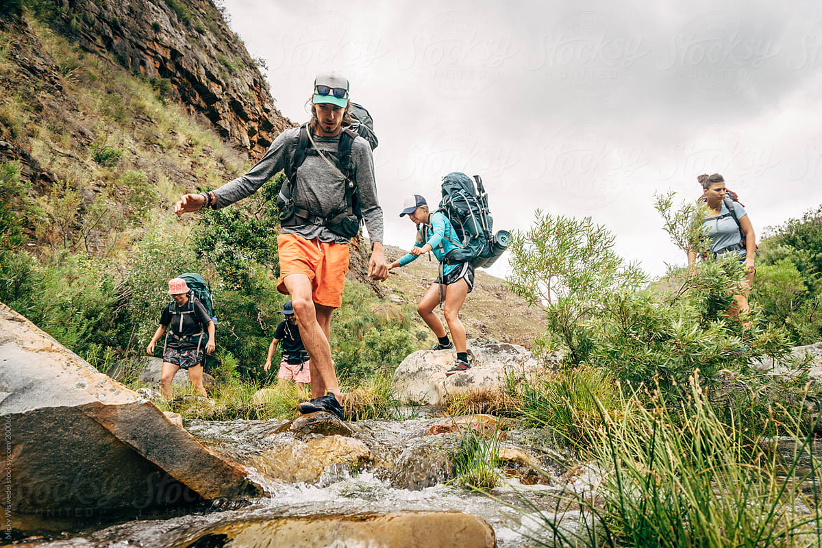 hikers crossing a mountain river