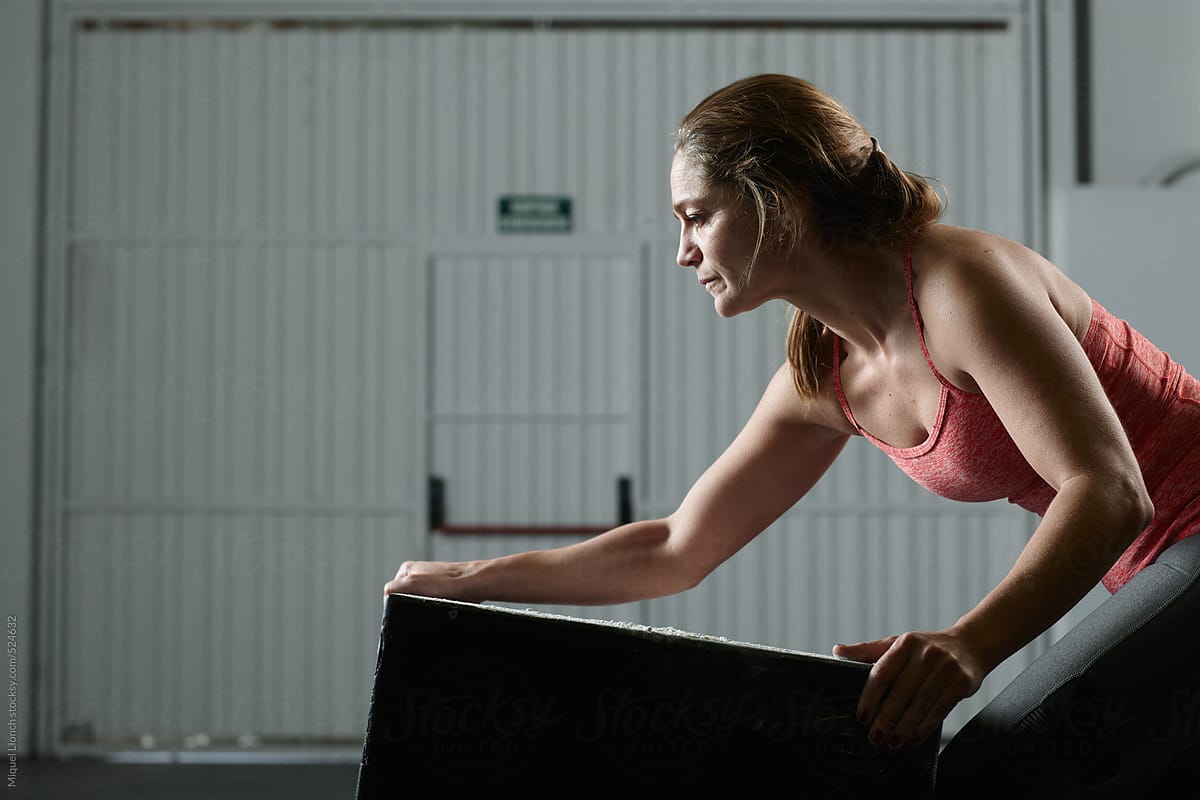 Adult woman preparing a jump box in a fit gym