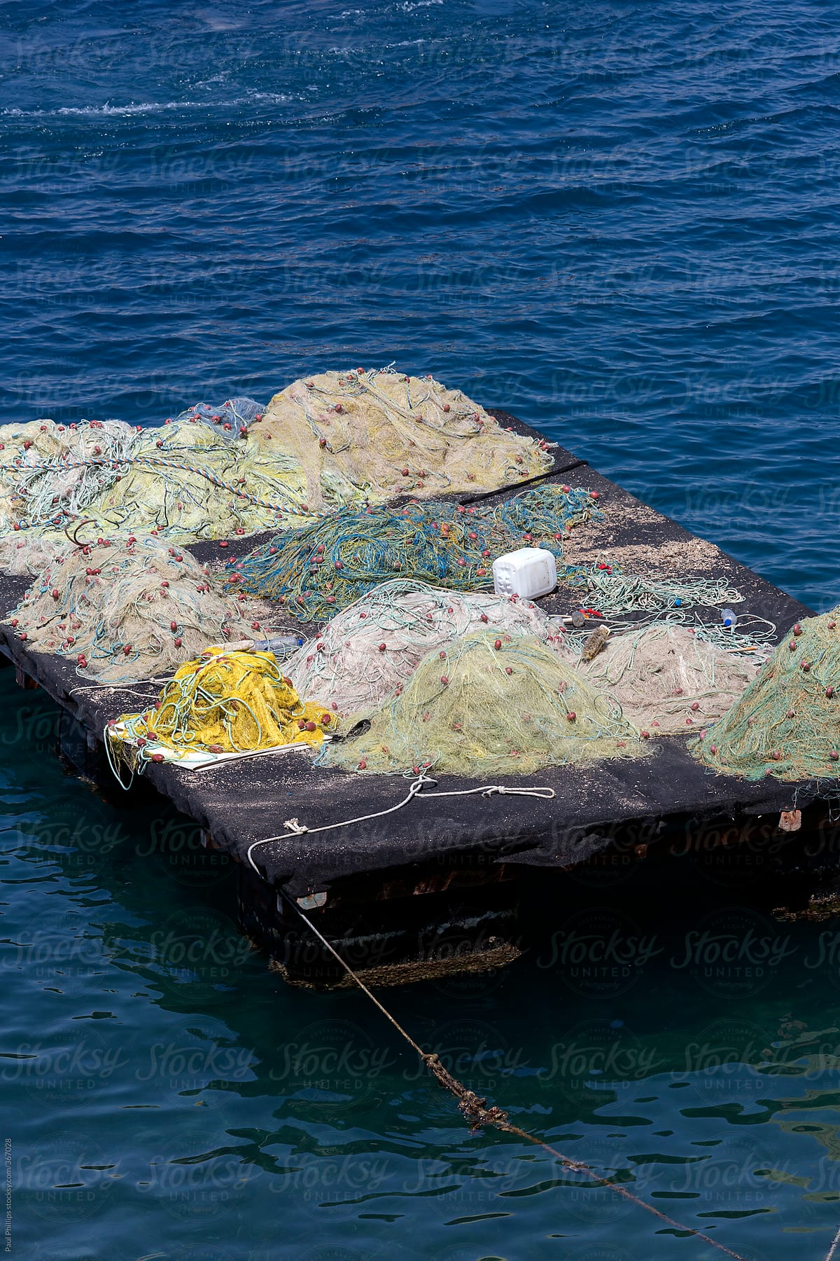 Wooden floating platform full of fishing nets drying in the sun