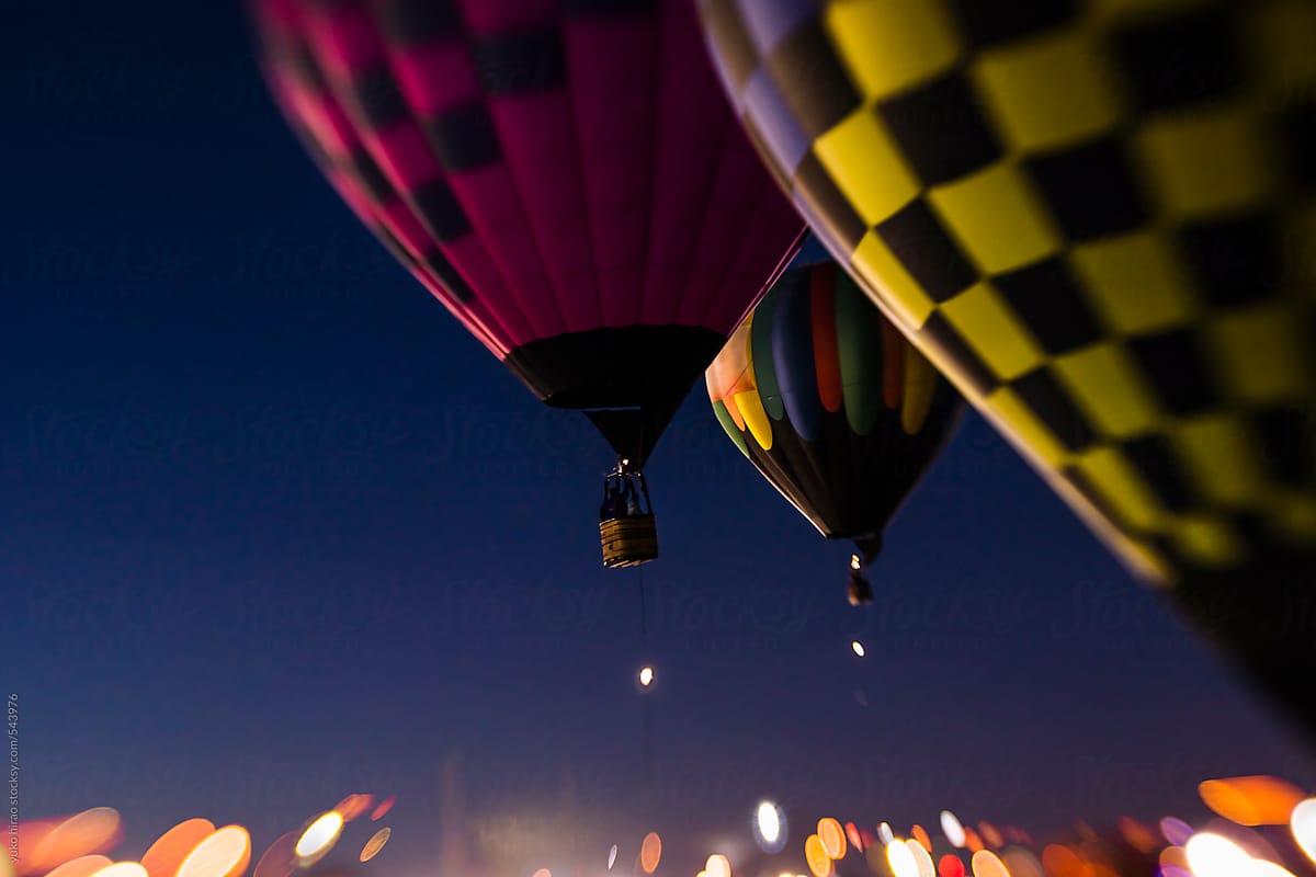 Hot air balloons, ascending for a morning patrol over lights