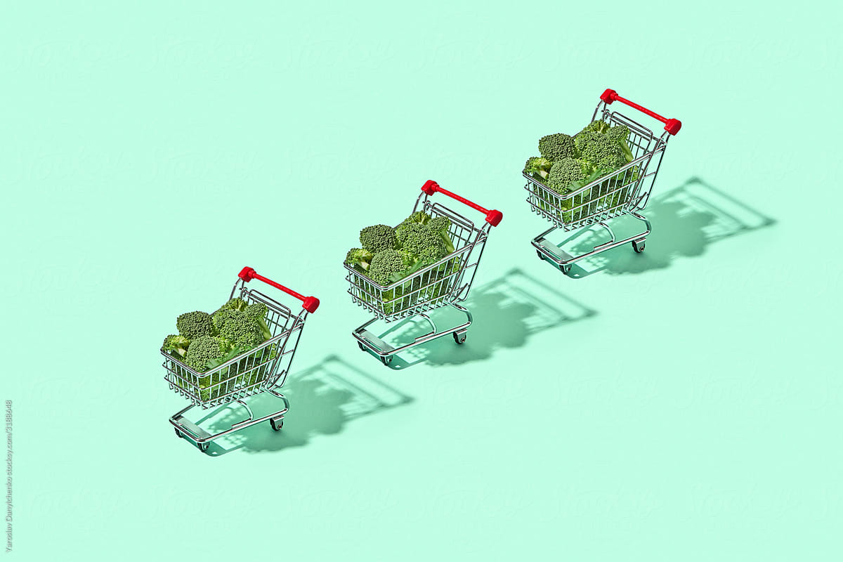 Shopping carts filled with broccoli.