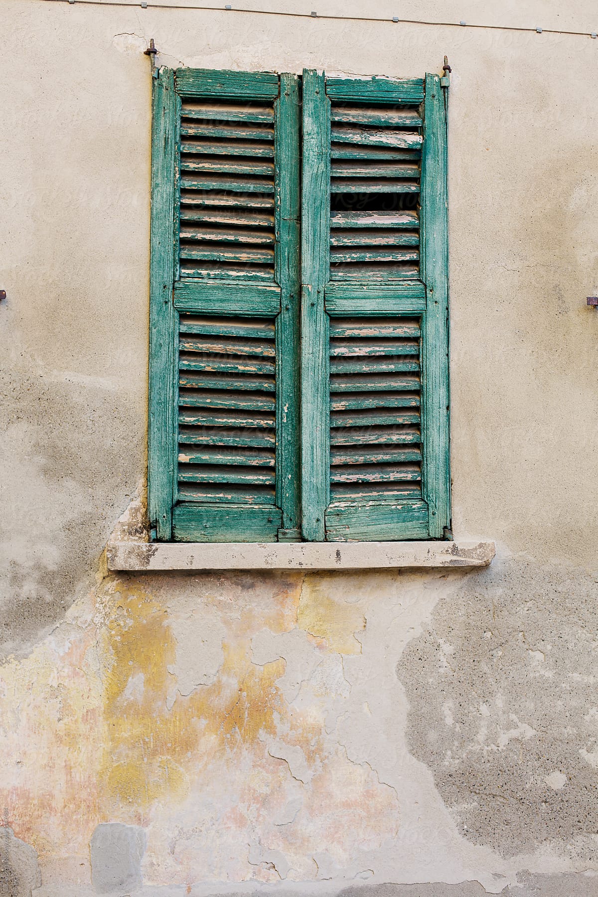Broken wooden window shutters seen on old italian building