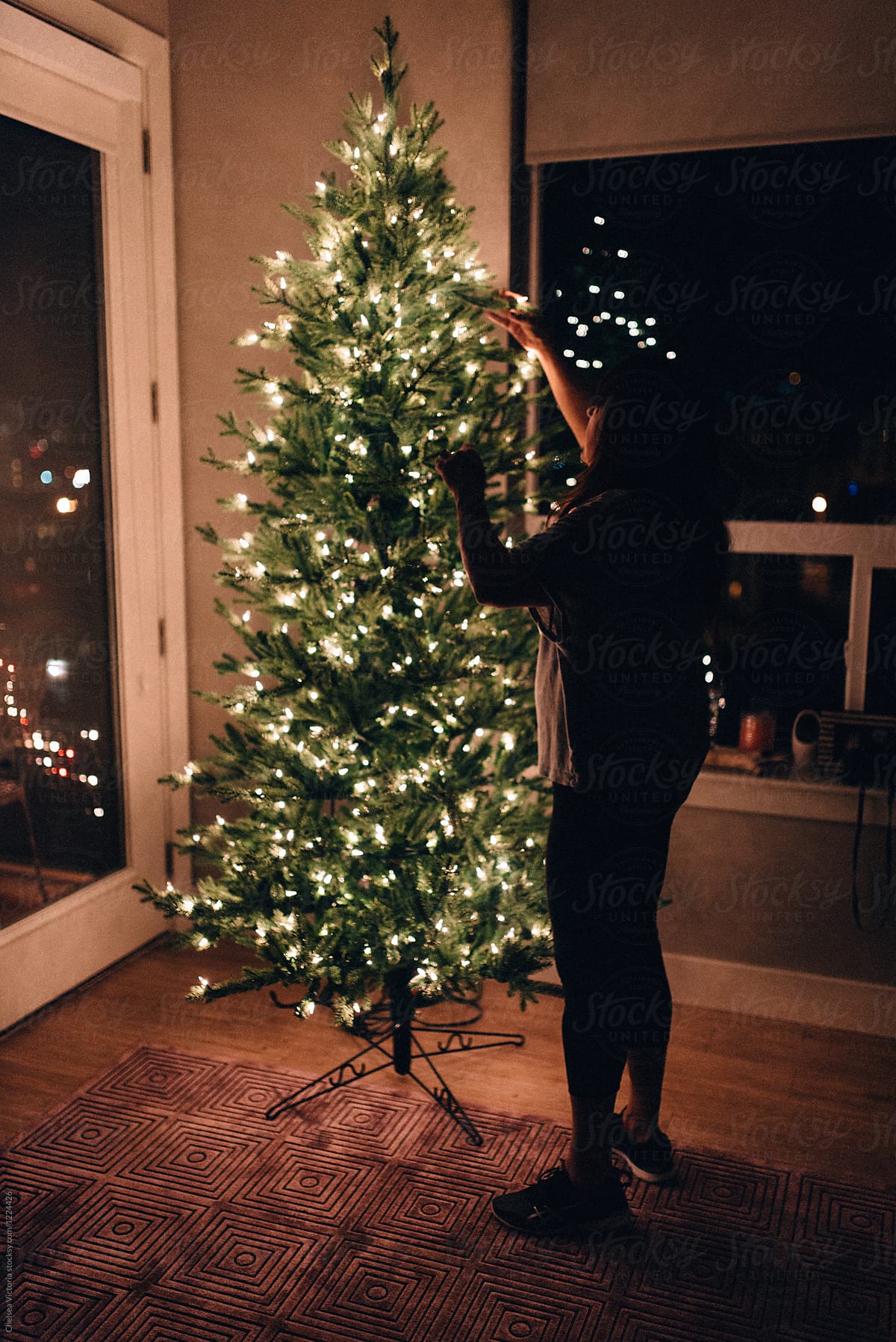 A woman decorating her Christmas tree