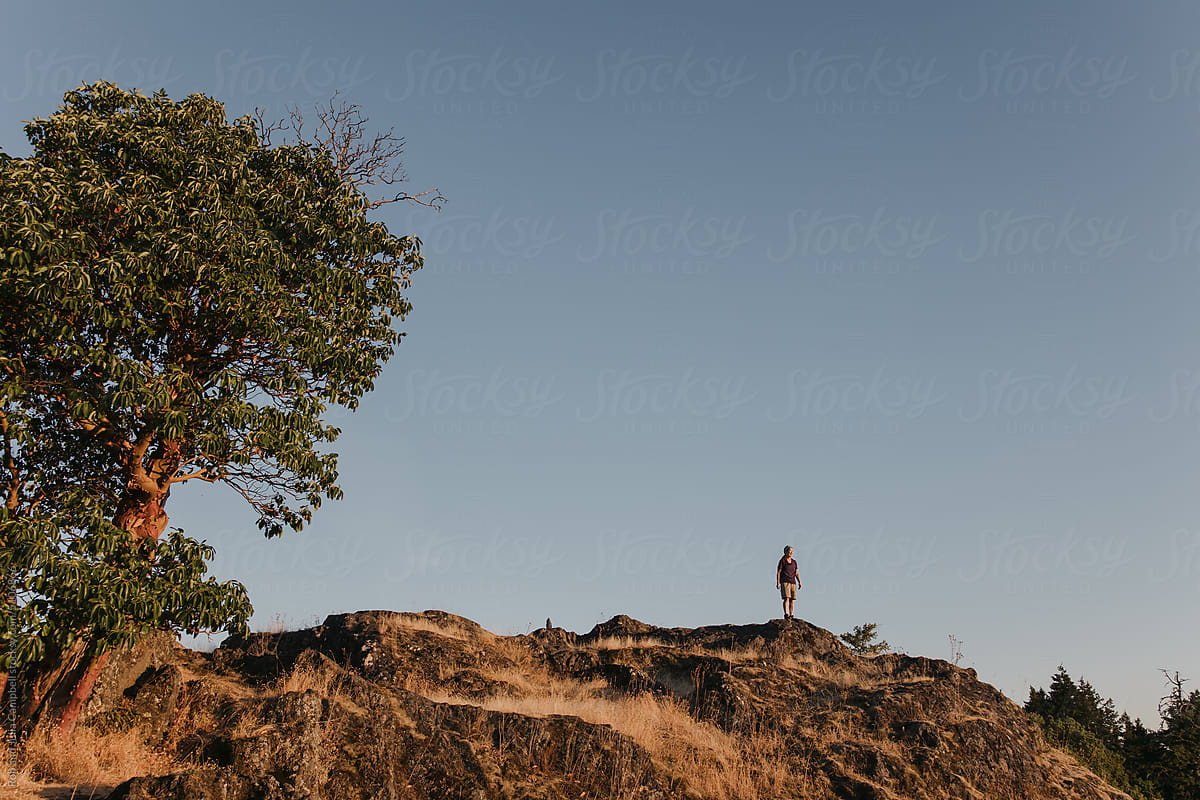 Woman looking at the morning view on a mountain top.