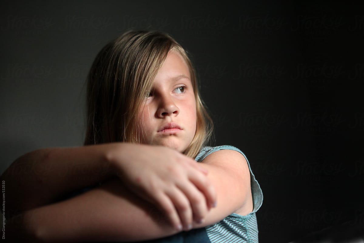 Portrait Of Young Girl Crossing Arms With Somber Expression By Dina