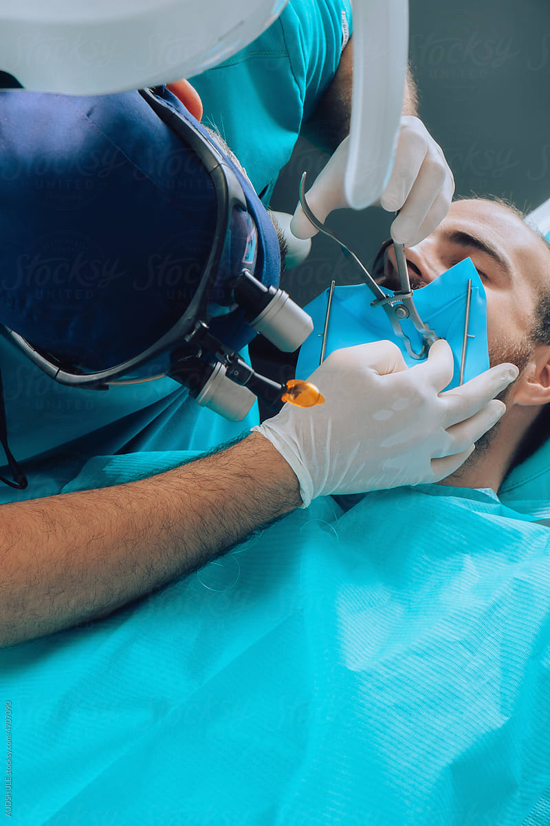 Dental Surgeon Making New Tooth filling.