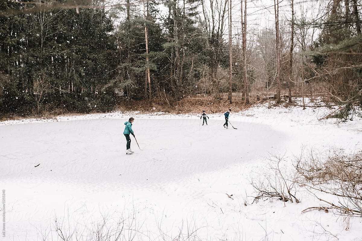 kids playing on frozen pond