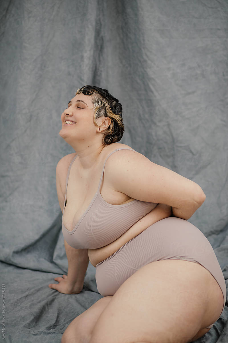 Emotional portrait of plus size young woman in lingerie