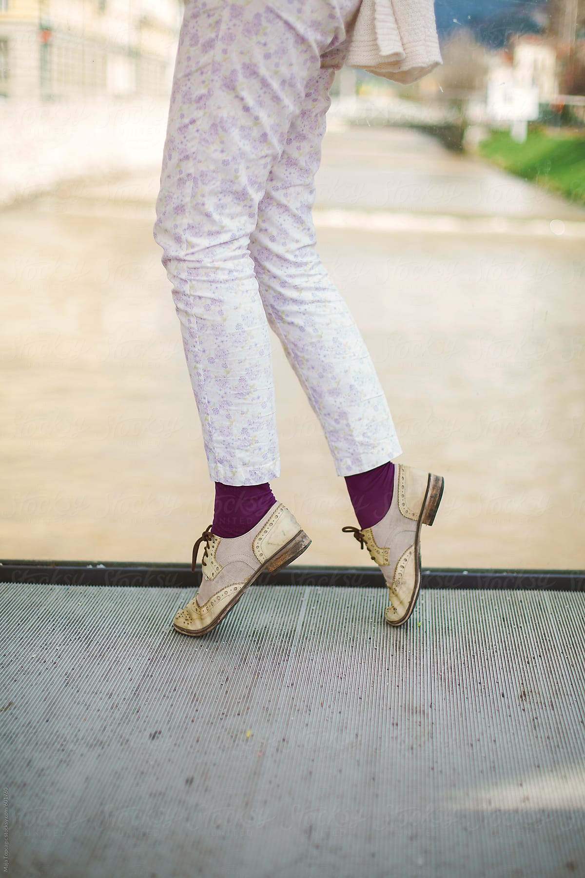 Female legs with vintage retro shoes on a bridge