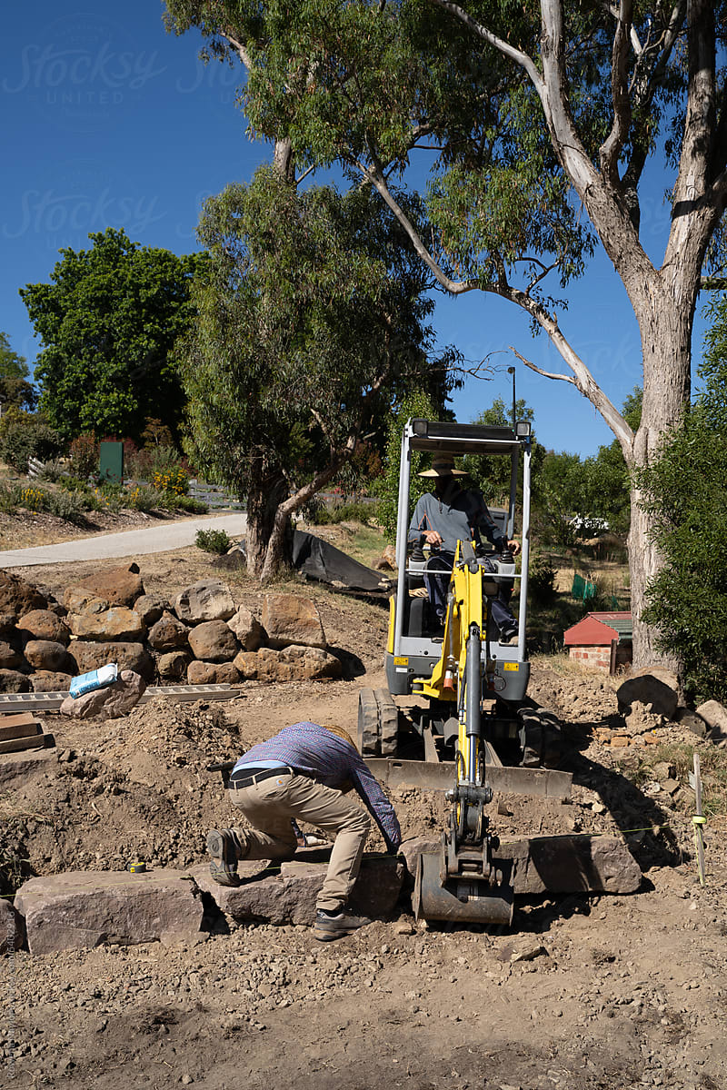 Landscape Architect placing rocks to create layered garden