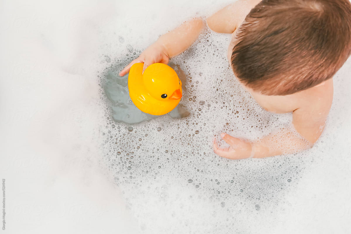Toddler with Rubber Duck Toy in the Bathtub