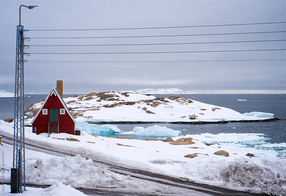 Greenland melts in spring thaw, Danish colonial house and electricity power lines