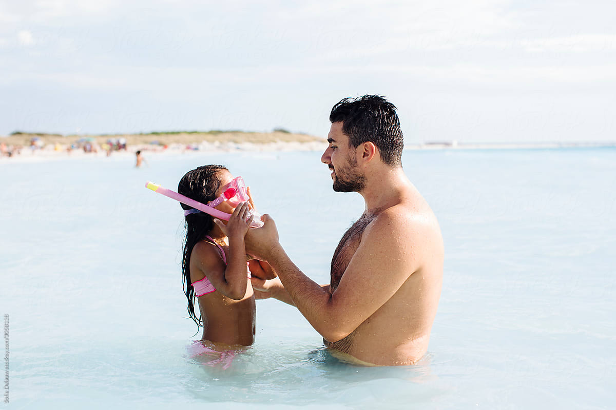 Father teaching daughter to swim
