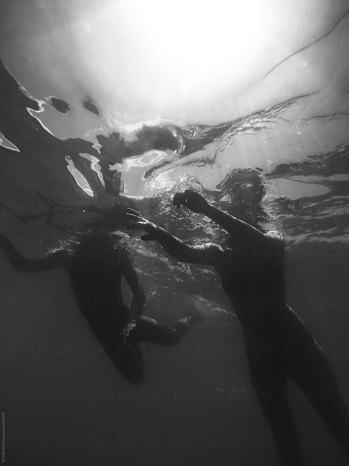 Two women underwater snorkeling.
