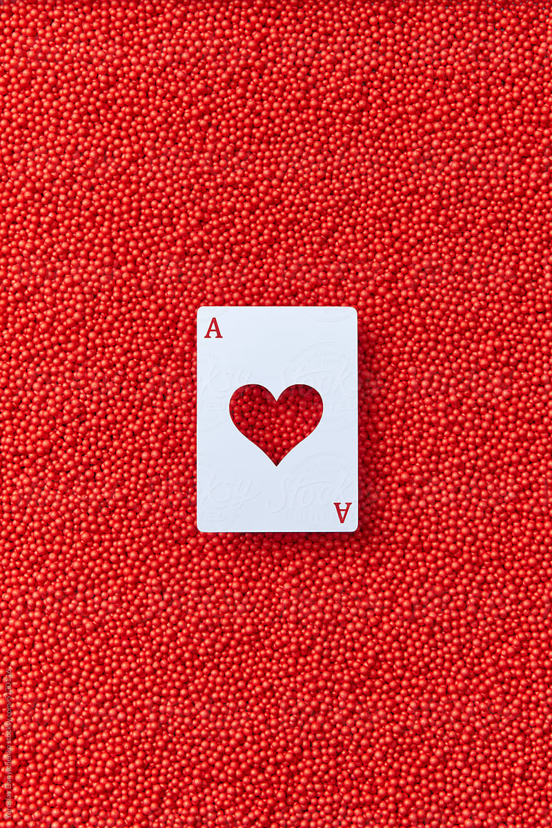 Ace card with heart on red balls background.