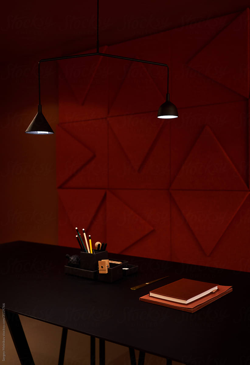 Table and chairs near geometric wall