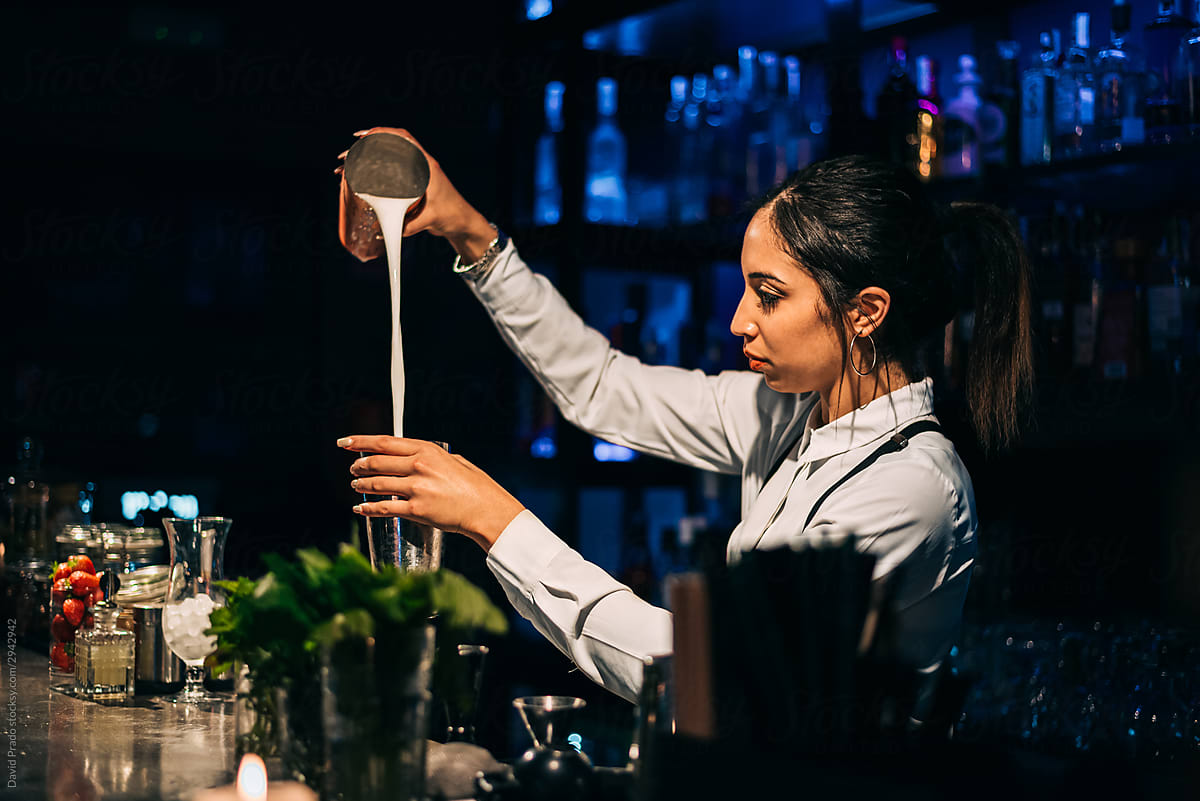Bartender mixing cocktail in bar