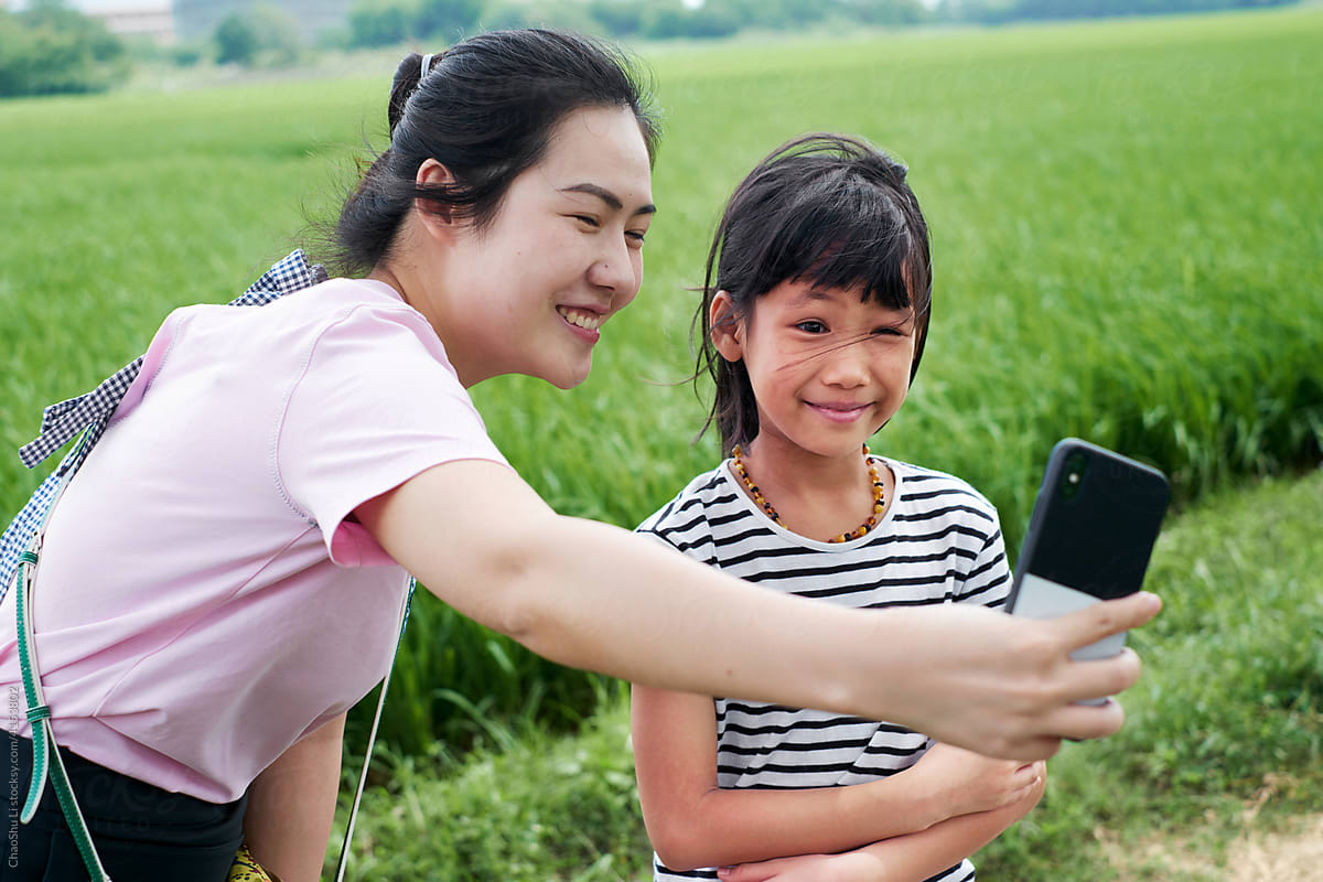 Asian little girl and aunt, playing in the rice field