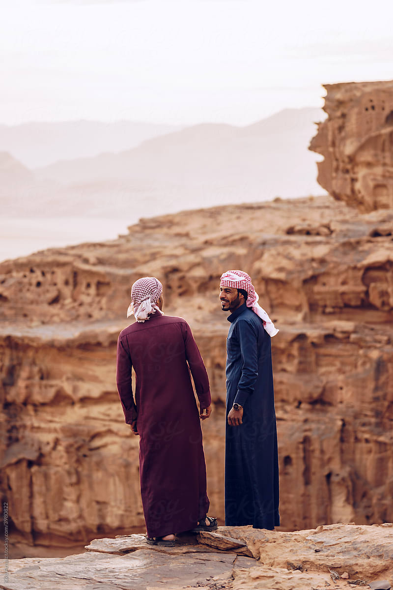 Arabic men talking near mountains