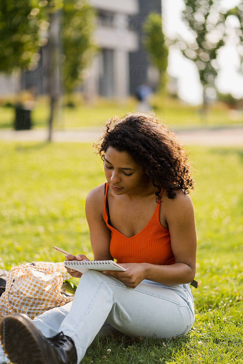 Female student in a park to write