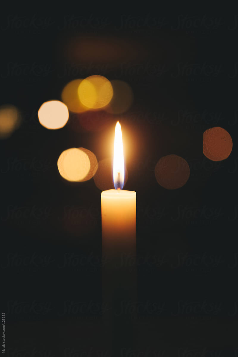 "Single Candle Flame, Black Background" by Stocksy Contributor "Mattia" - Stocksy