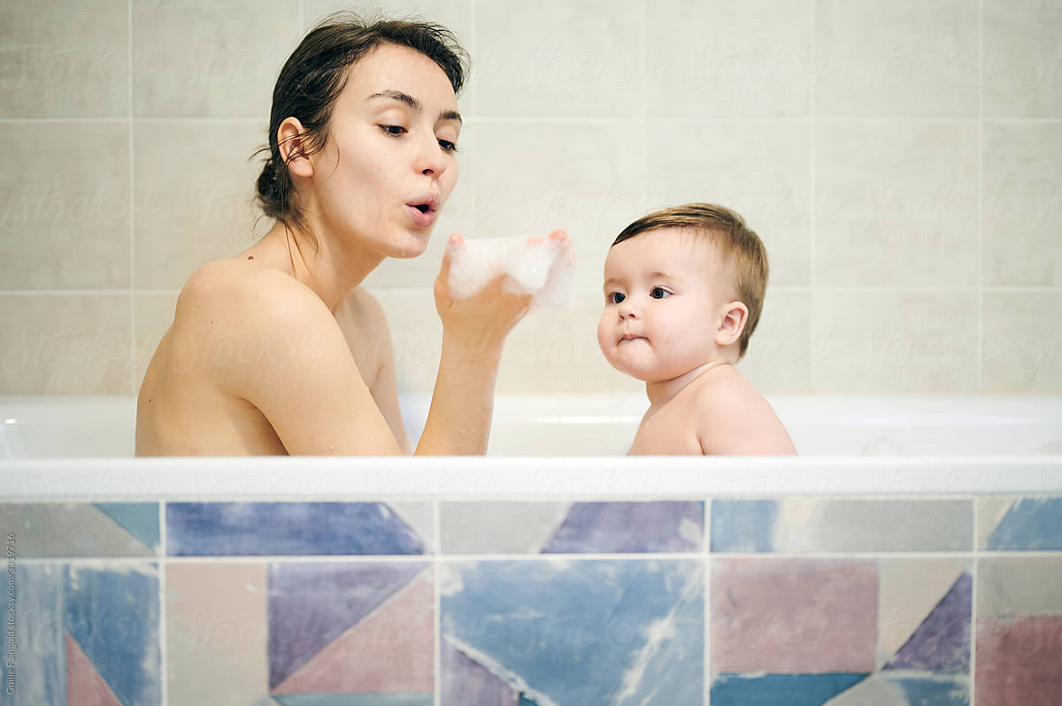 Mom and baby having fun in bathroom