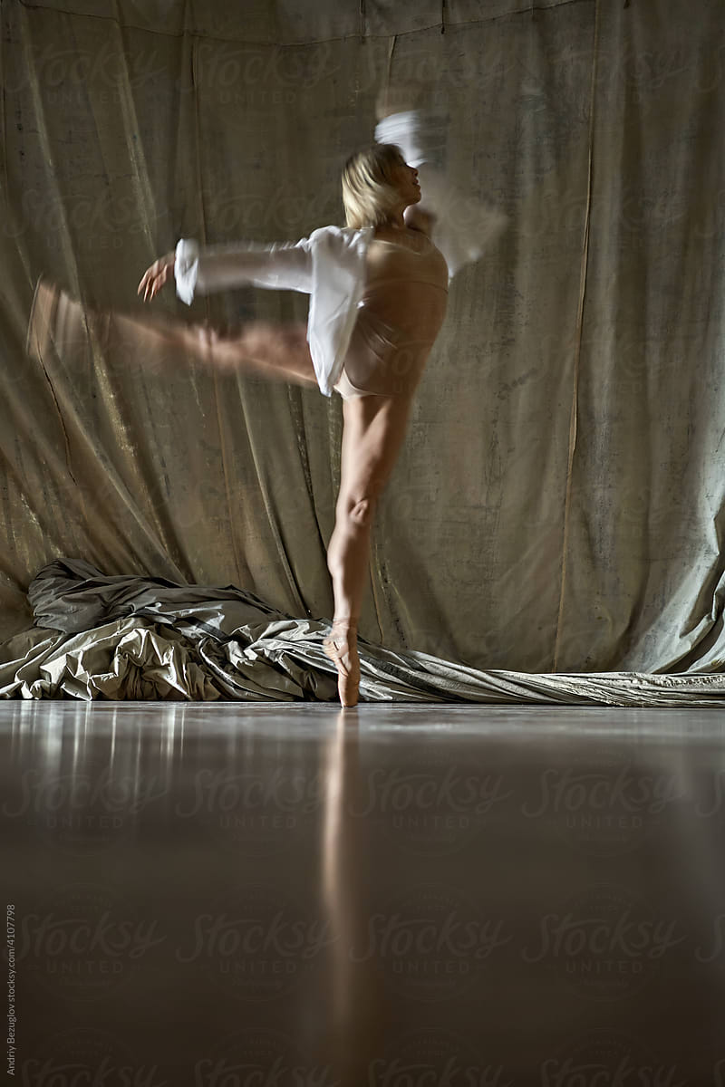 Blonde ballet dancer performing inside dance hall